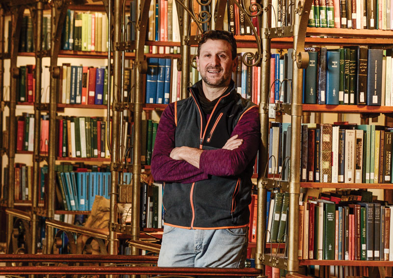 Dr. Frank Rossi standing in a library